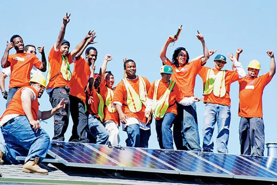 Graduating trainees at Solar Richmond, a green-collar job program in California's Bay Area, celebrate a successful installation.