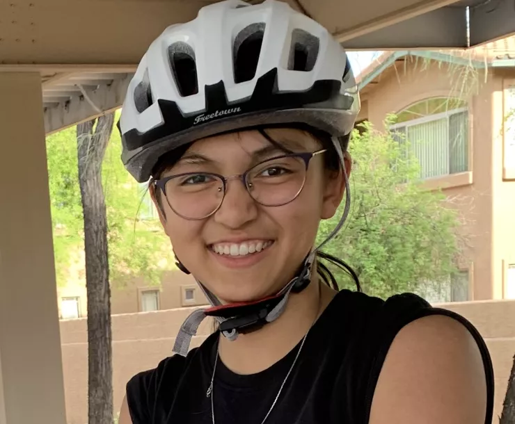 Lyla Yango smiling while wearing a white bike helmet