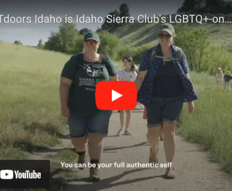 Screenshot of video on You Tube, two women holding hands on hike