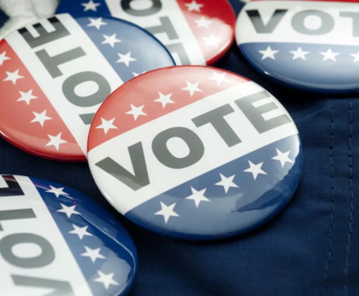 Vote election campaign button badges and the United States of America flag