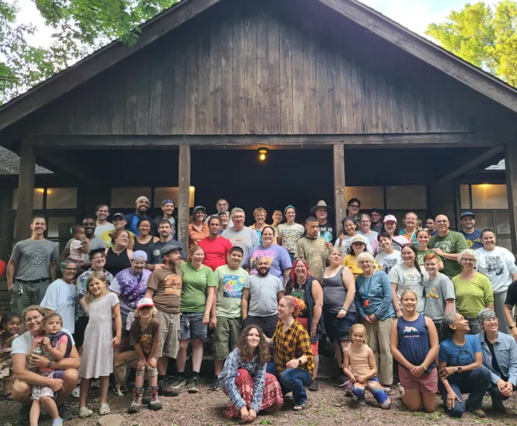 A diverse group of Hickory Run outing participants in front of the dining hall at Hickory Run State Park.