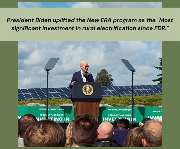 Photo of President Biden standing in front of a solar panel