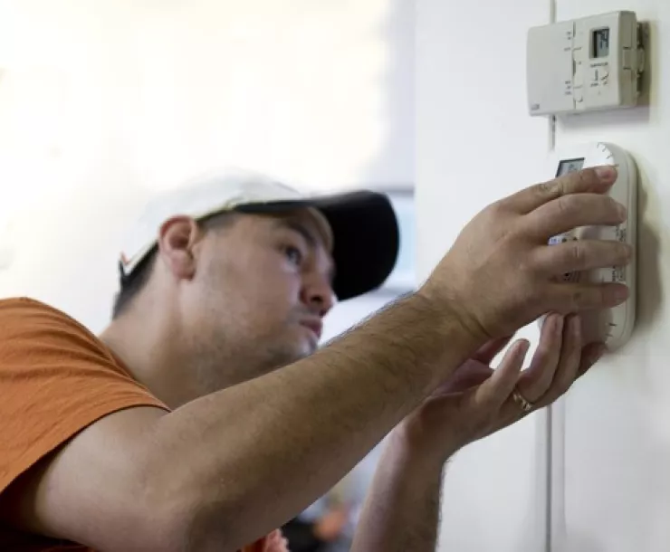 New home thermostat being installed