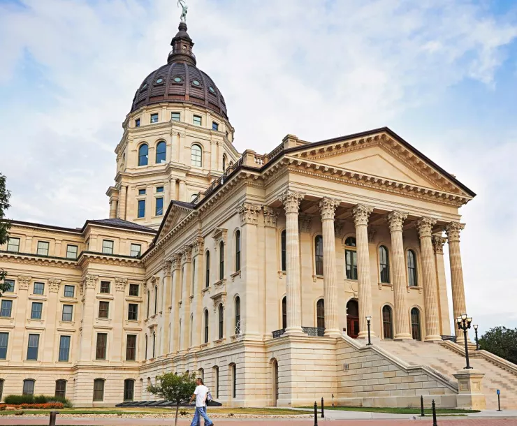 light colored building with dome, front pipllars, and lots of steps