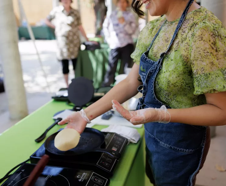 Woman cooking tortillas on an induction stove