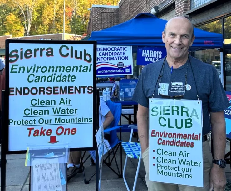 WNC Group volunteer Gordon Grant hands out endorsement information in Buncombe County