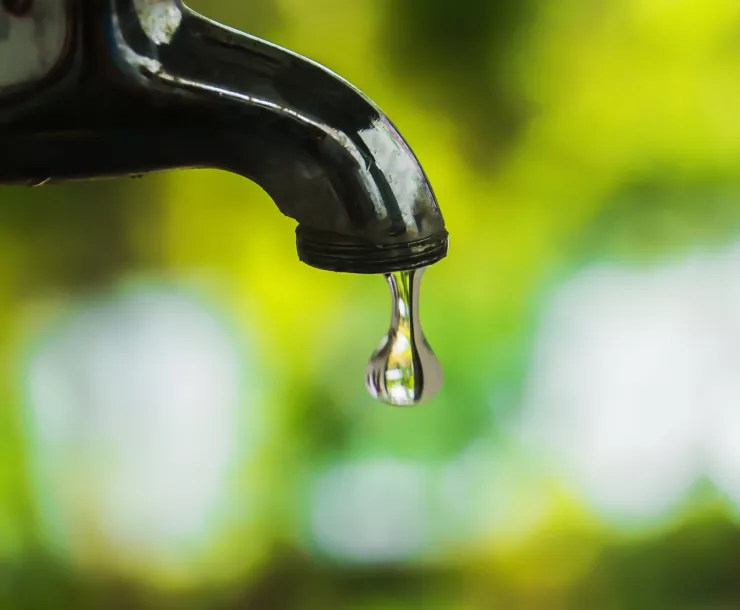 Photo of a water faucet dripping 