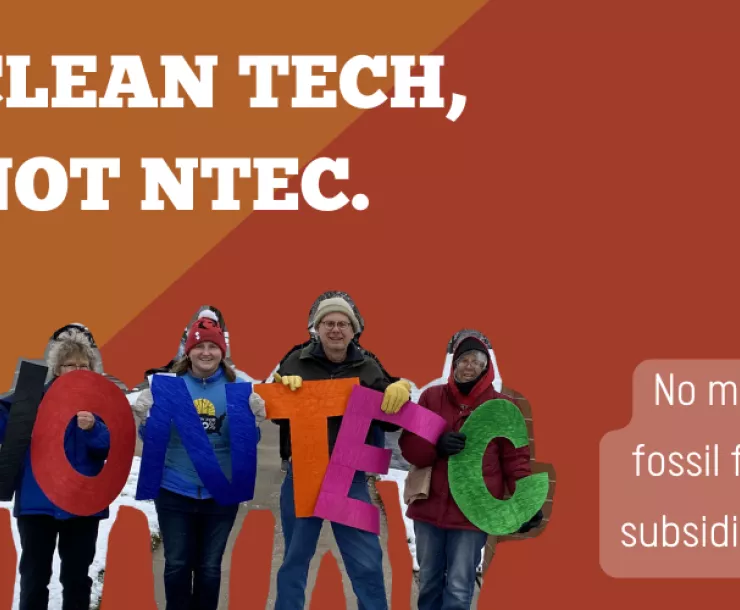 A group of people hold large letters that spell out "No NTEC" and white text reads, "Clean tech, note NTEC. No more fossil fuel subsidies!"