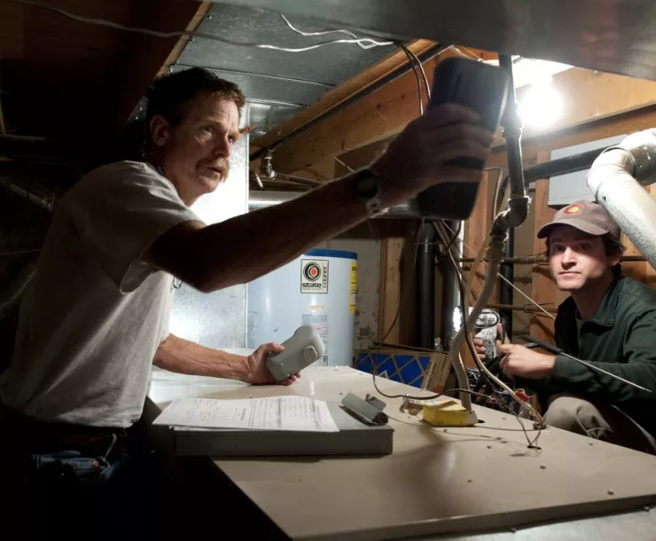 two people working on HVAC