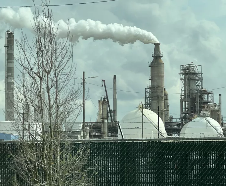 houaton fossil fuel plant with smoke cloud