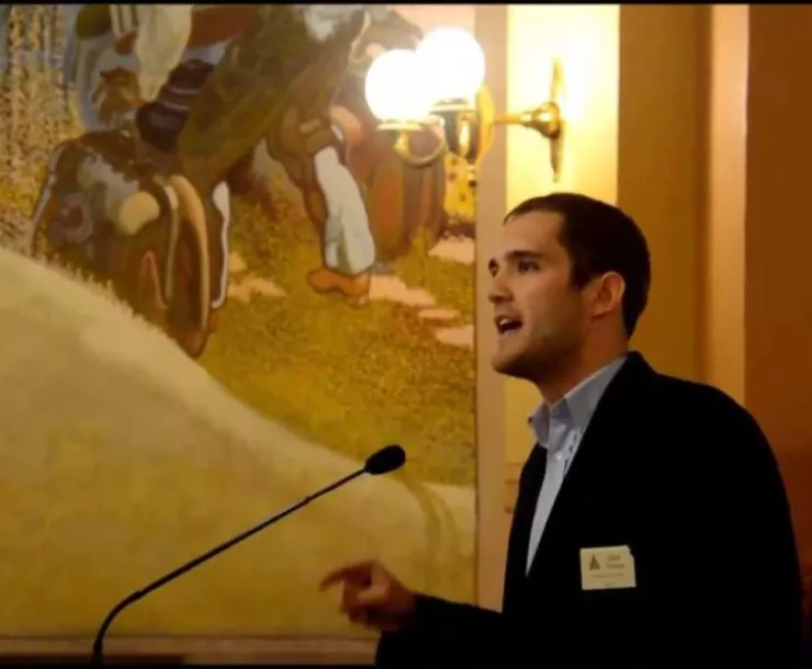 young White man in suit speaking at microphone in Kansas House of Representatives