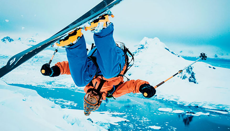 Author Ben Shook does a front flip off a glacier.
