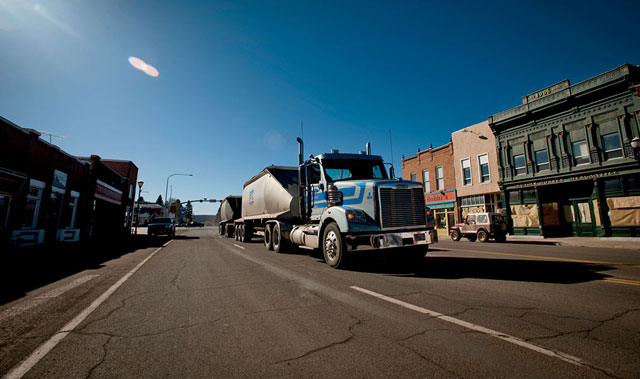 A coal truck rumbles past her shop in Panguitch, Utah. | Ace Kvale/TandemStock