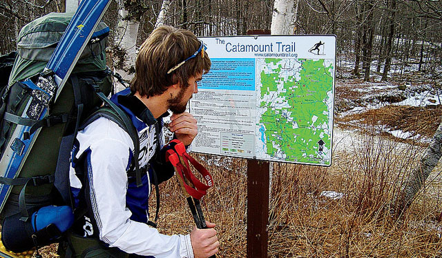 Expedition partner Ross contemplates a trailside map.