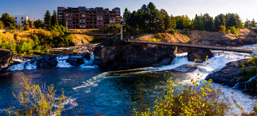 A landscape photo of a suspension bridge over two sections of the Spokane River, Spokane County, Washington State.