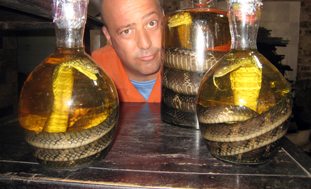 Andrew with jars of cobra liquor. | Courtesy of the Travel Channel