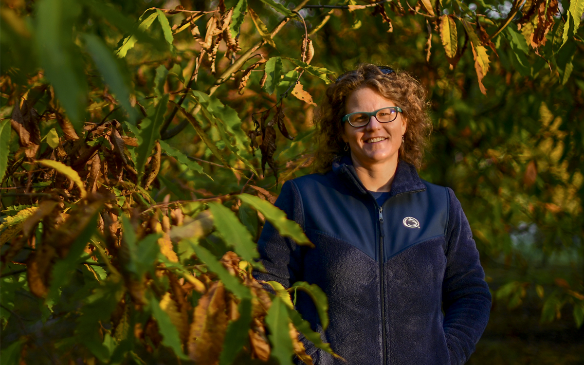 Sara Fern Fitzsimmons wears a blue zip-up jacket and smiles at the camera.